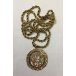 A 14CT GOLD PIERCED MEDALLION PENDANT With stylized petal motif, suspended from a 9ct gold rope