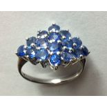 A VINTAGE WHITE GOLD AND SAPPHIRE CLUSTER RING Set with round cut sapphires forming a lozenge