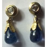 A PAIR OF VINTAGE CONTINENTAL YELLOW METAL, DIAMOND AND TANZANITE DROP EARRINGS Having a collet