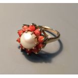 A 9CT GOLD, CORAL AND SPLIT PEARL RING The pearl enclosed by ten coral stones (size N). (pearl