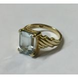 A 9CT GOLD AND PASTE RING Having a single cushion cut stone flanked by raised shoulder (size K).