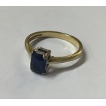 AN 18CT GOLD AND SAPPHIRE RING With a cushion cut sapphire set on a basket clasp.