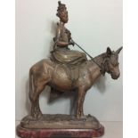 A 19TH CENTURY FRENCH SPELTER FIGURE OF A MAIDEN ON A DONKEY In elegant pose and on a rustic base,