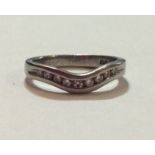 A PLATINUM AND DIAMOND HALF ETERNITY RING Having a row of round cut diamonds, channel set in a