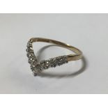 A 9CT GOLD AND DIAMOND WISHBONE RING With nine round cut diamonds interspersed by white metal