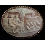 AN EARLY 20TH CENTURY 9CT GOLD SIGNED OVAL SHELL CAMEO BROOCH Finely carved with a landscape view of