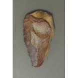 A STONE AGE AXEHEAD. (h 4.5cm x w 14.5cm x d 8cm)