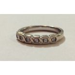 AN 18CT WHITE GOLD AND DIAMOND HALF ETERNITY RING The row of princess cut diamonds held in a