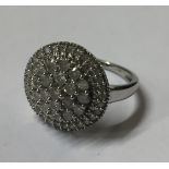 A 9CT WHITE GOLD AND DIAMOND CLUSTER RING Having nineteen round cut diamonds contained within a