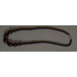 A VINTAGE CHERRY AMBER NECKLACE The a single strand of spherical beads. (approx 31cm) (largest