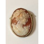 A 20TH CENTURY 9CT GOLD CAMEO BROOCH The oval cameo having a depiction of a young woman, mounted