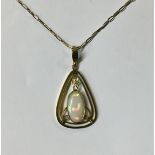 A 9CT GOLD AND OPAL PENDANT The open back design cantered by a single oval opal, complete with a 9ct