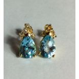 A PAIR OF 14CT GOLD, AQUAMARINE AND DIAMOND EARRINGS Having a pear cut aquamarine set with a