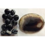 A COLLECTION OF NINE VICTORIAN BANDED SPHERICAL AGATE BEADS With white banding, together with a