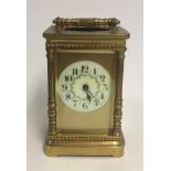 A LATE 19TH CENTURY BRASS CASED CHIMING CARRIAGE CLOCK With floral decorations. (12cm x 7.5cm x 7.