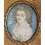 A LATE 18TH CENTURY OVAL MINIATURE PORTRAIT Of a beautiful young woman, contained in a swept gilt