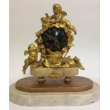 A 19TH CENTURY BRONZE ORMOLU AND MARBLE GLOBE DESK CLOCK Mounted with a winged cherub and a birds
