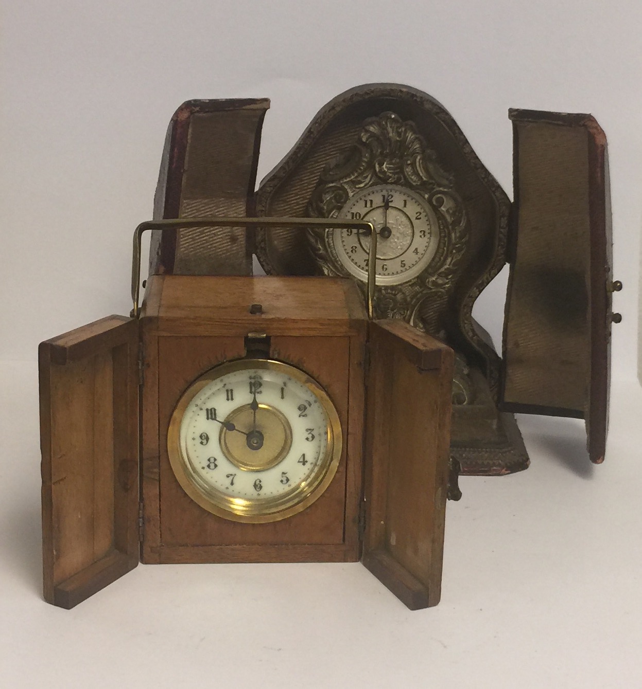 TWO 19TH CENTURY TRAVELLING CLOCKS White metal and walnut cased. (l 12cm)