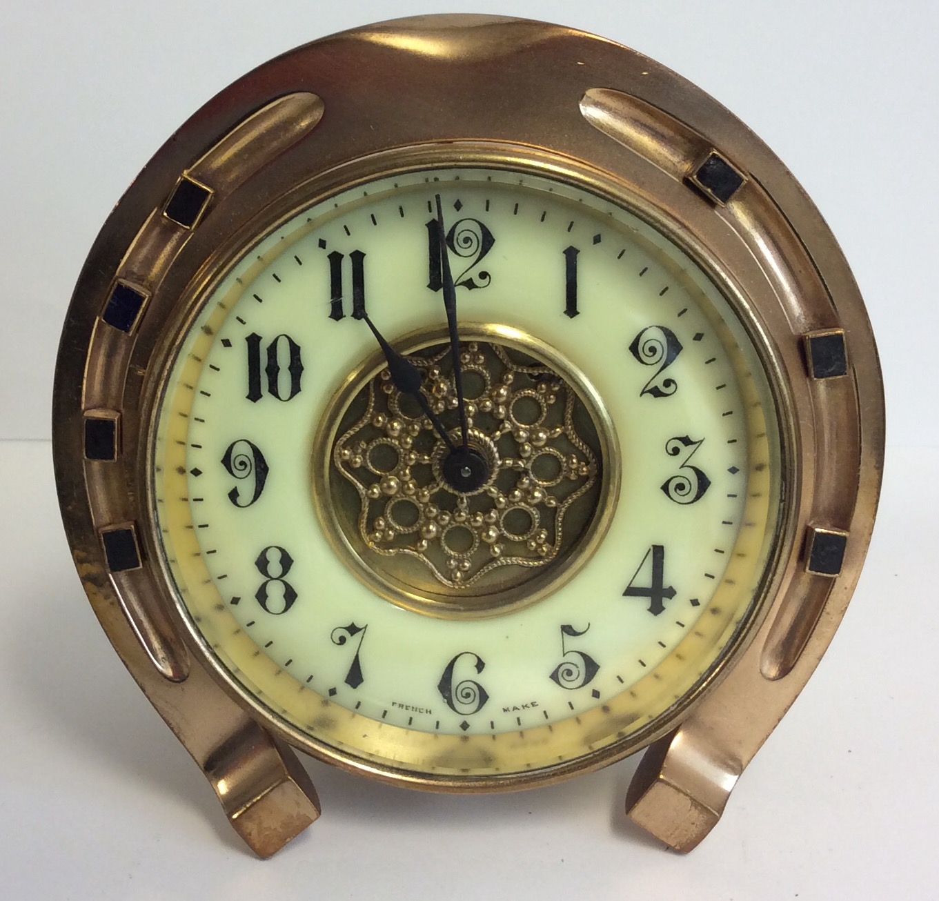 A 19TH CENTURY GILT BRASS HORSESHOE FORM MANTLE CLOCK The cylinder movement marked 'S. Frères &