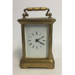 A 19TH/20TH CENTURY MINIATURE BRASS CASED CARRIAGE CLOCK. (8cm x 4.5cm x 5.5cm)