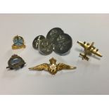 A REVERSE GLASS PAINTED R.A.F. BADGE Death by Night, sold together with four R.A.F badges, to