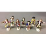 A CONTINENTAL PORCELAIN SEVEN PIECE MONKEY BAND Including conductor with gold anchor mark. (h 14cm)