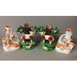 STAFFORDSHIRE, A PAIR OF POTTERY RAM AND SHEEP SPILL HOLDERS With bocage and a pair of flatback deer