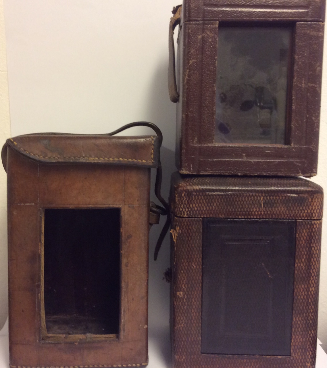 A COLLECTION OF THREE 19TH CENTURY LEATHER CARRIAGE CLOCK CASES Each having a carry handle.