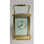 A LATE 19TH/EARLY 20TH CENTURY GILDED BRONZE REPEATING CARRIAGE CLOCK Having four bevelled glass