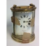 MALLETT OF BATH, AN EARLY 20TH CENTURY GILDED BRASS CIRCULAR CARRIAGE CLOCK Having four convex glass