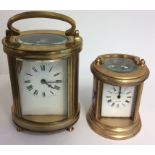 TWO EARLY 20TH CENTURY GILDED BRASS OVAL CARRIAGE CLOCKS One having painted figural panels marked