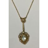 AN EARLY 20TH CENTURY YELLOW METAL, AQUAMARINE AND PEARL PENDENT With four pearls over an oval cut