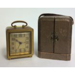 AN EARLY 20TH CENTURY FRENCH GILDED BRONZE TRAVEL CLOCK AND CASE Square shape with Arabic numerals