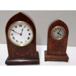 AN EARLY 20TH CENTURY AMBONA CASED CLOCK, along with another, both of gothic design. (largest 26 cm)