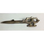 A WORLD WAR II BRITISH COMMANDO SILVER CAP BADGE Modelled as a dagger with a knuckleduster grip (