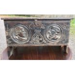 A 17TH CENTURY OAK COFFER OF SMALL PROPORTIONS Carved with the date 1635 and portraits centred