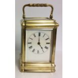 A LATE 19TH/EARLY 20TH CENTURY GILT BRASS CHIMING CARRIAGE CLOCK Having four bevelled glass panels