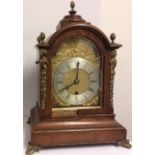 A 19TH CENTURY OAK AND BRASS MANTLE CLOCK Having a dome top with brass acorn finials and a gilt