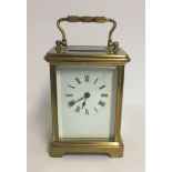 AN EARLY 20TH CENTURY BRASS CASED CARRIAGE CLOCK. (11cm x 8cm x 6cm)