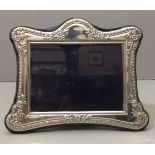 KITNEY & CO., A HALLMARKED SILVER PICTURE FRAME With gadrooned edge and foliate relief