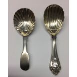 TWO SILVER CADDY SPOONS One Victorian, the other Georgian, both with shell form bowls.