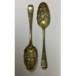 A PAIR OF 18TH CENTURY SILVER GILT SERVING SPOONS With repoussé bowls and engraved handles.