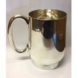 AN EARLY 20TH CENTURY SILVER TANKARD Of tapering form with a 'C' shaped handle, hallmarked London,