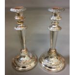 A PAIR OF NEOCLASSICAL STYLE SILVER PLATE CANDLESTICKS Of tapering form with 'C' scroll decoration