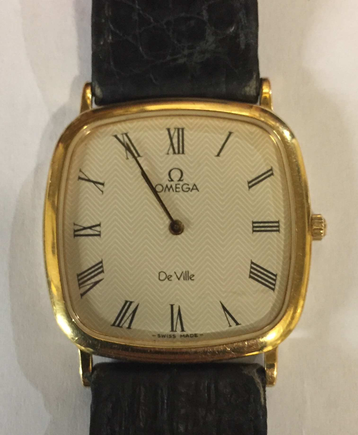 OMEGA, DEVILLE, A VINTAGE GOLD PLATED GENT'S SLIMLINE WRISTWATCH The square case with cream tone