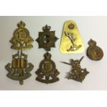 A SELECTION OF SEVEN BRITISH BRASS CAP BADGES.
