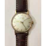 LONGINES, A GENT'S 9CT GOLD WRISTWATCH The silvered dial with yellow metal batons and a brown