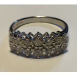 AN 18CT WHITE GOLD AND DIAMOND RING Comprising of fourteen round cut diamonds set in two rows of