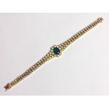 AN 18CT YELLOW GOLD BRACELET SET WITH 108 BRILLIANT CUT DIAMONDS AND A LARGE CENTRAL EMERALD. (