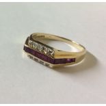 A 14CT GOLD, RUBY AND DIAMOND RING Having a single row of square cut rubies flanked by two rows of